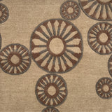 Close-up of a handknotted rug with circular patterns in brown and beige.