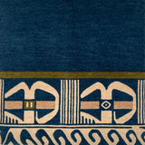 Close-up of a blue carpet with beige geometric patterns