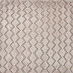 Detail of a hand knotted rug with a raised cut pile diamond stripe in grey.