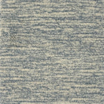 Handknotted rug with textural blue and cream design. 