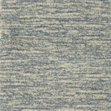 Handknotted rug with textural blue and cream design. 