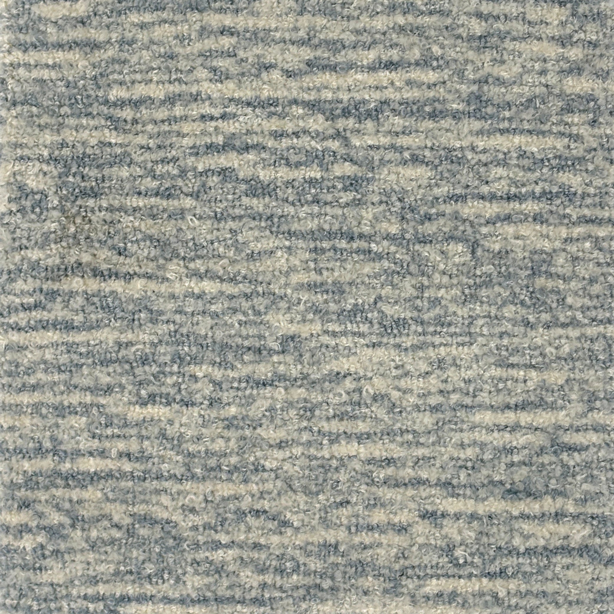 Handknotted rug with textural blue and cream design. 