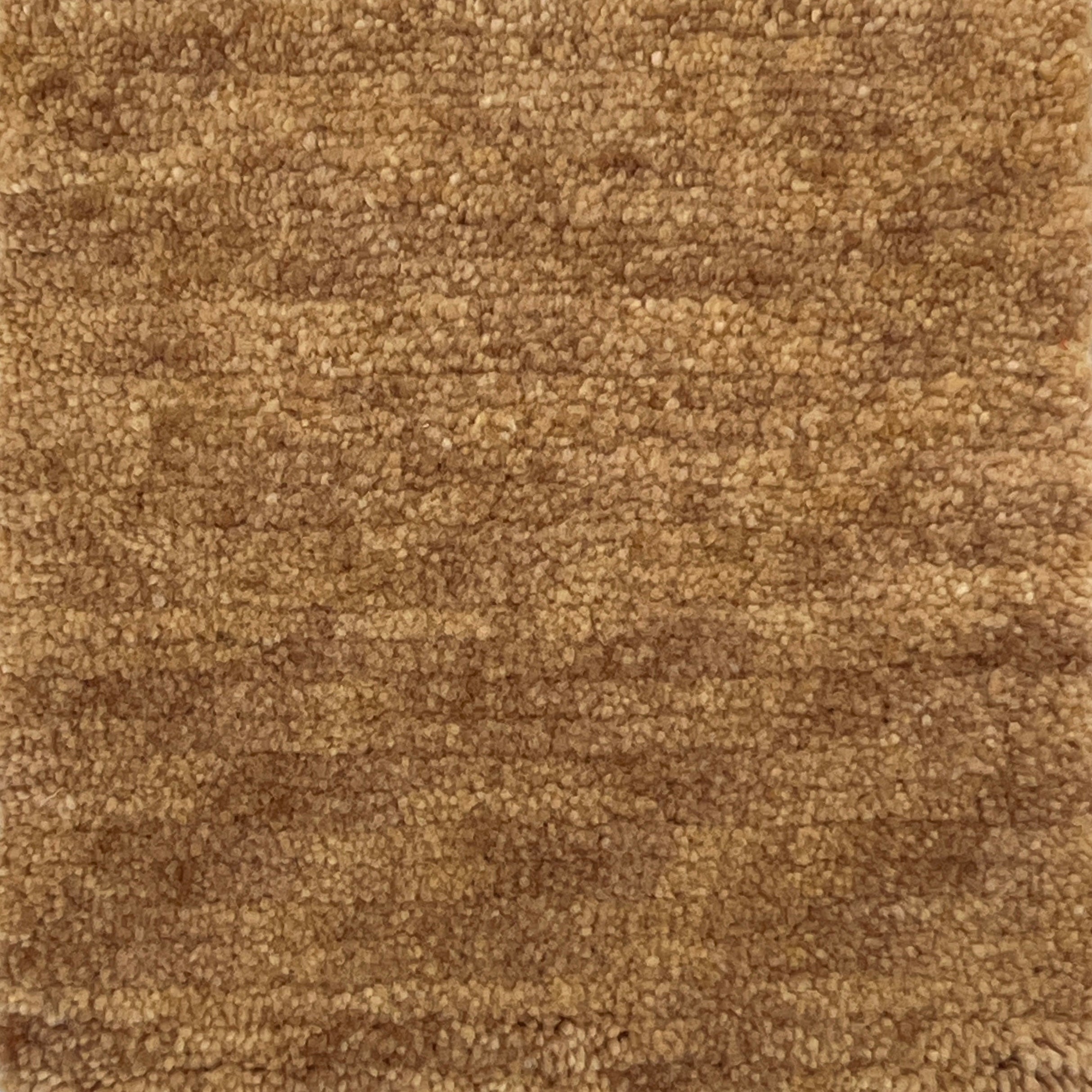 Handknotted cut pile rug in warm tan.