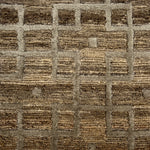 Close-up of a textured brown and beige carpet with a checkered pattern