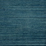 A close-up of a handwoven carpet in a heathered teal colorway. 