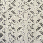 Fabric in a diamond grid pattern in charcoal on a tan field.
