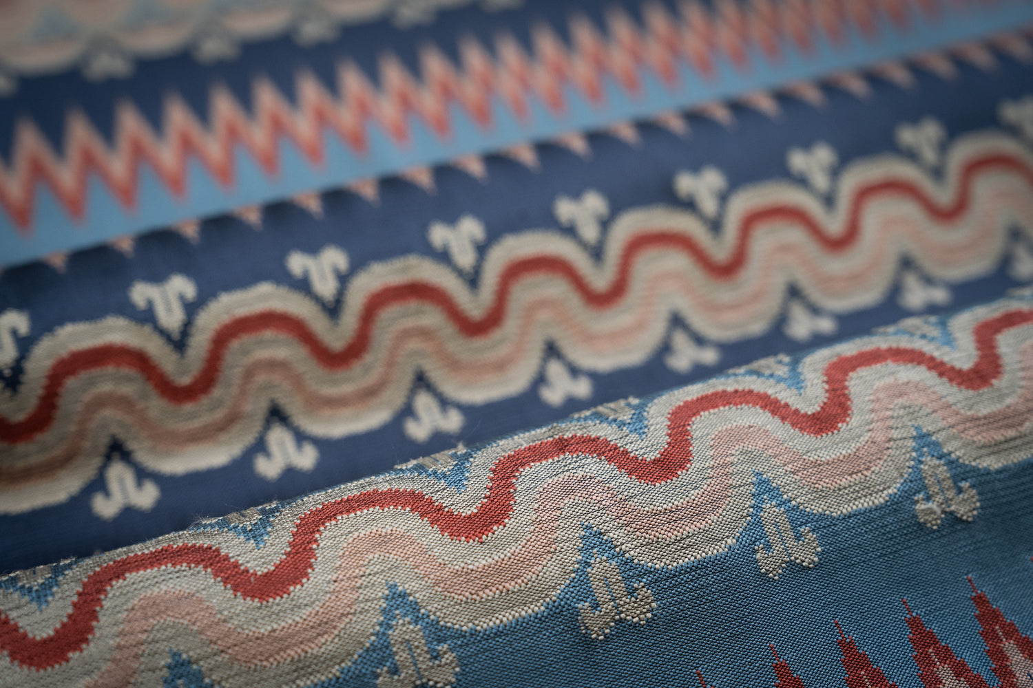 Close-up of fabric with red, white, and blue wavy stripe pattern. 
