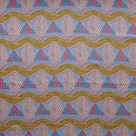 A close-up of a patterned fabric featuring repeating rows of stylized pink leaves, blue and red striped triangles and wavy orange-green lines on a blue background