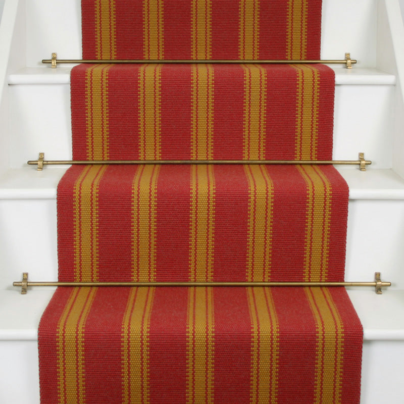 Striped flatweave runner in red and orange on white staircase