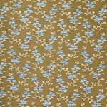A close-up of a woven fabric pattern featuring a repeating geometric design of light blue diamond floral shapes and cream branch motifs on a warm tan background.
