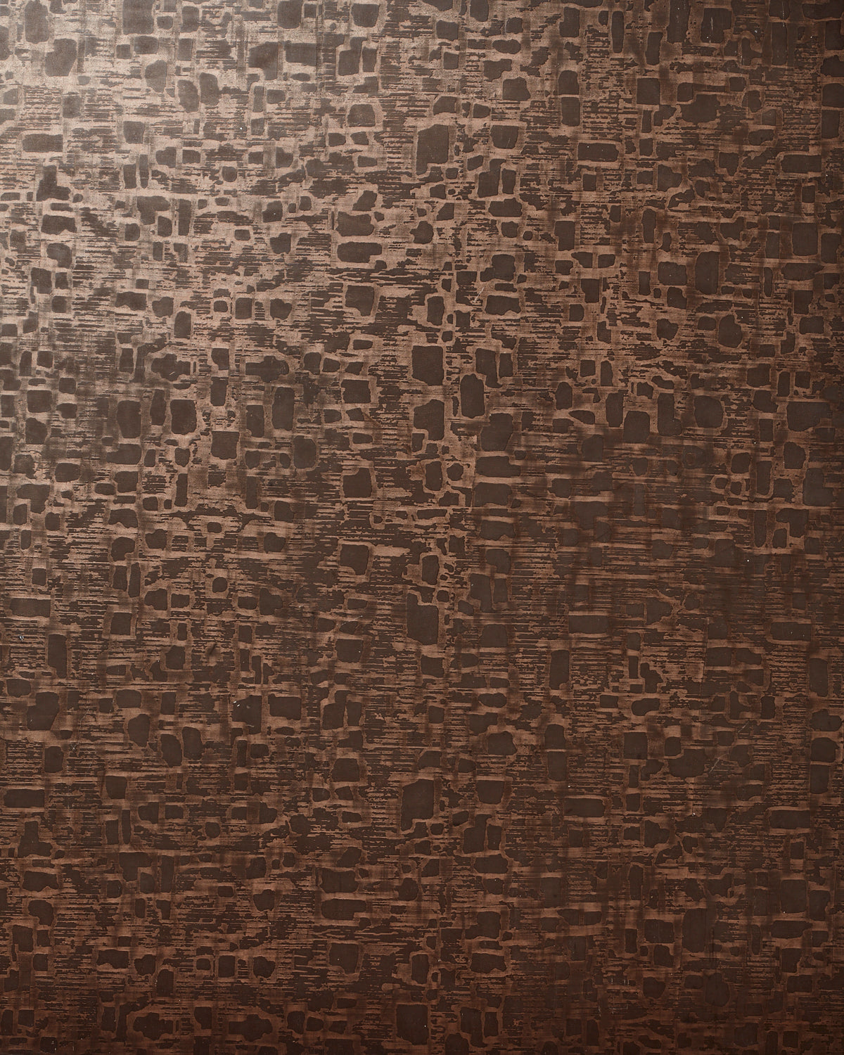Detail of wallpaper in an irregular textural print in metallic brown on a brown field.