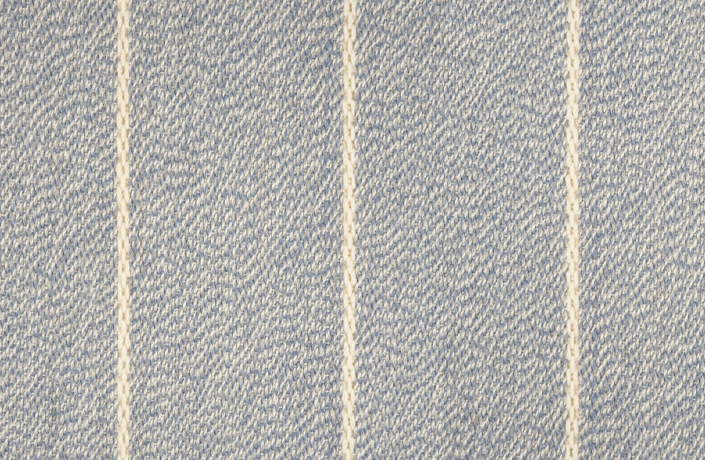 Broadloom carpet in a thin ivory stripe on a field of light blue.