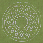 Detail of fabric in a repeating circular geometric print in light gray on a green field.