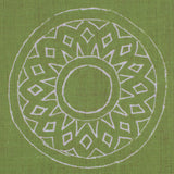 Detail of fabric in a repeating circular geometric print in light gray on a green field.