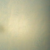 Detail of a wallpaper in an abstract ridged texture in metallic green.