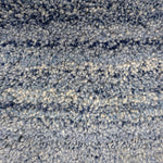 Handknotted cut pile rug in a strie ombre in shades of blue and cream