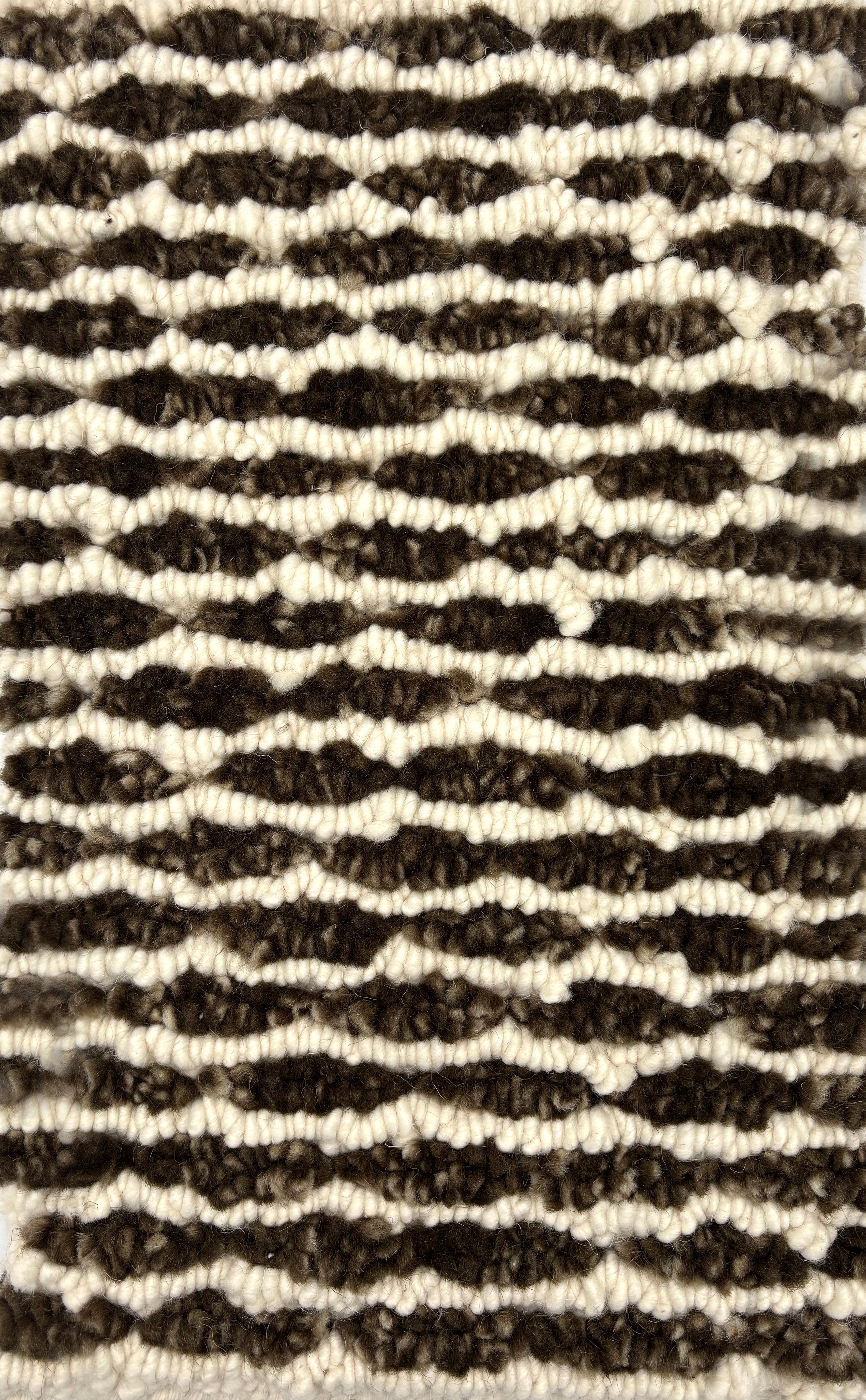 Handknotted rug in a wavy stripe in chocoliate brown and cream. 