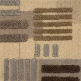 Close-up of a handknotted rug with a raised geometric pattern in beige, taupe, gray, and dark brown.
