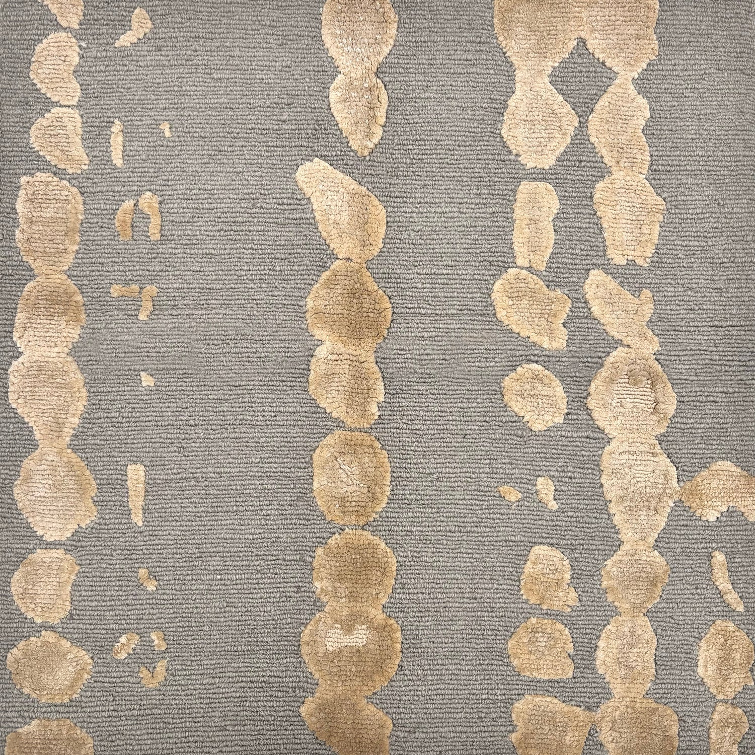 Handknotted rug sample in a bold painterly design in taupe and grey. 