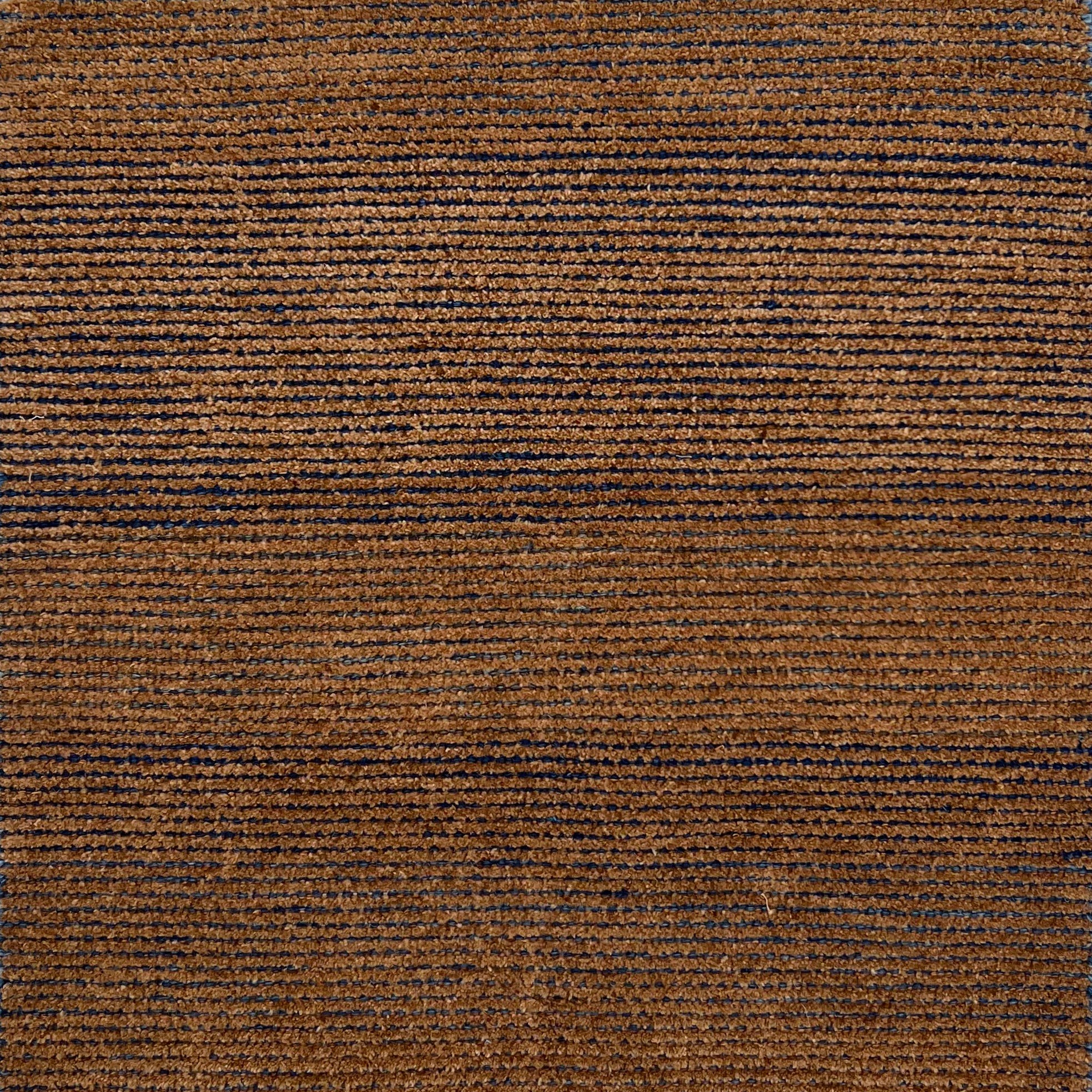 Handknotted rug sample in a warm brown with navy stripe.