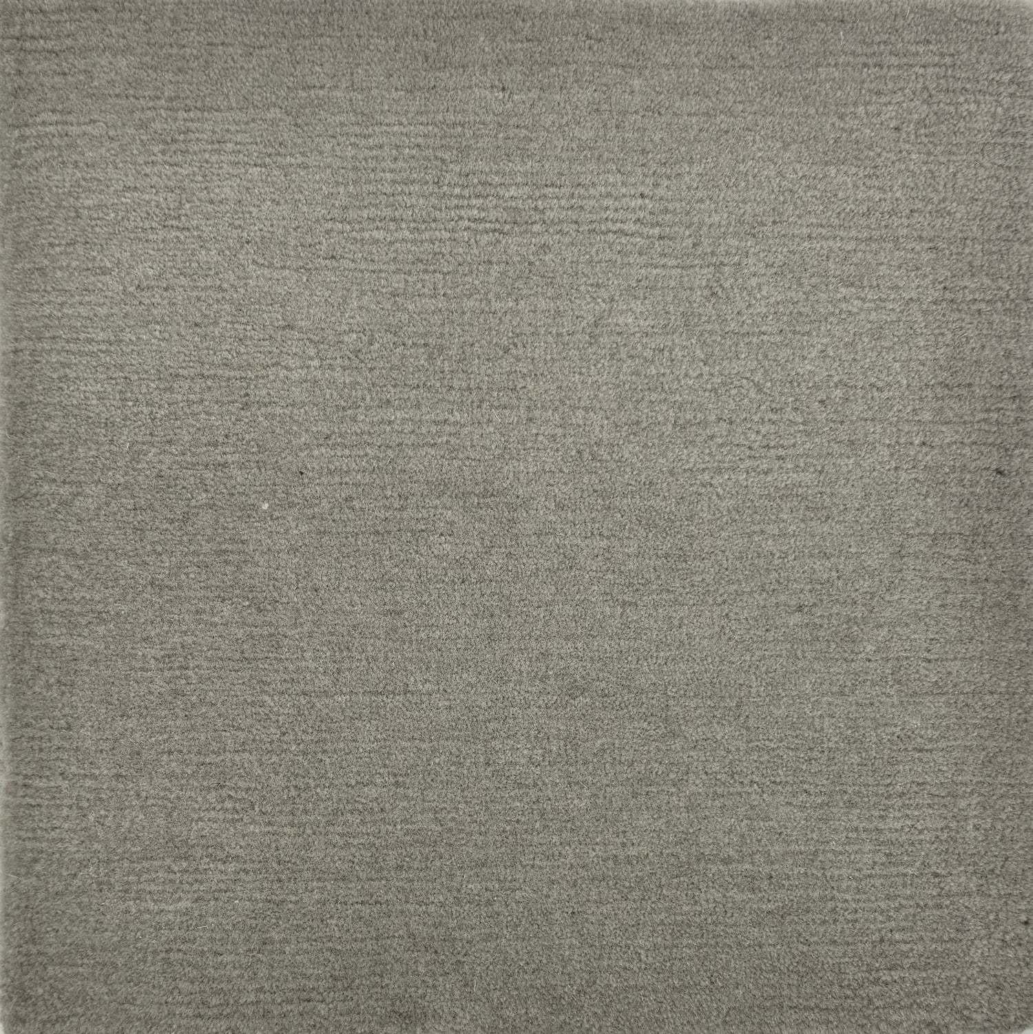 Handknotted rug sample in solid grey.