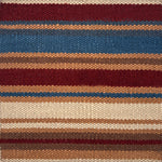 Flatweave rug in a variegated stripe in brown, tan, teal, cream and red. 