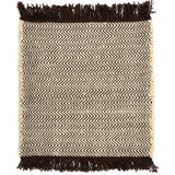 Handwoven rug in a chevron stripe in cream and chocolate brown with fringed edges.