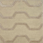 Tonal cream handknotted rug with a raised silk geometric zigzag pattern in on a solid wool cut pile ground. 