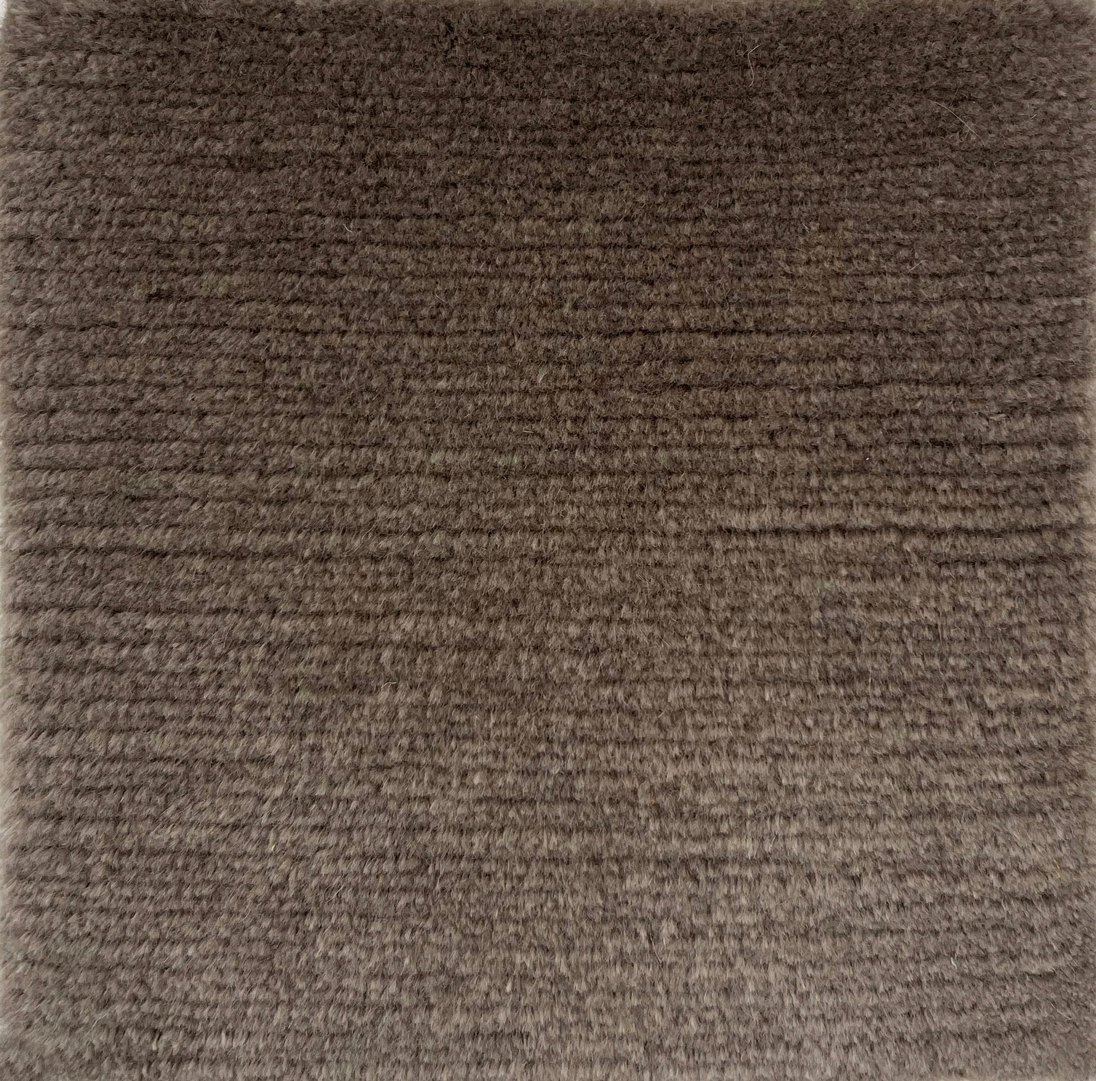 Handknotted solid cut pile rug in brown wool. 