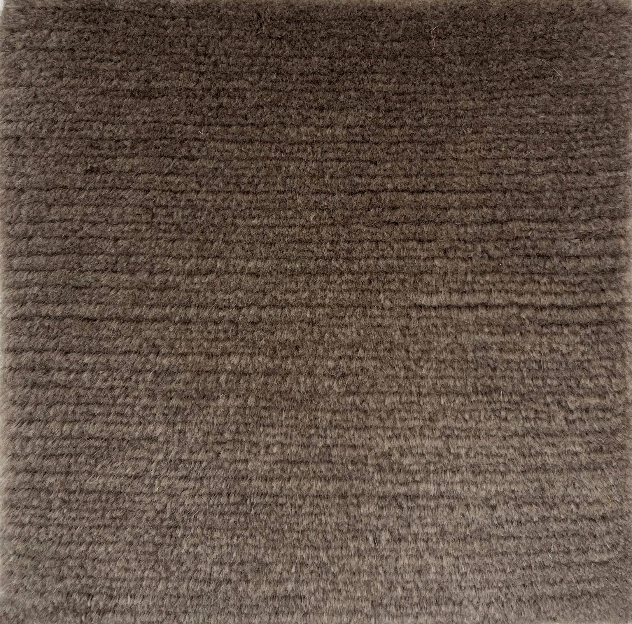 Handknotted solid cut pile rug in brown wool. 