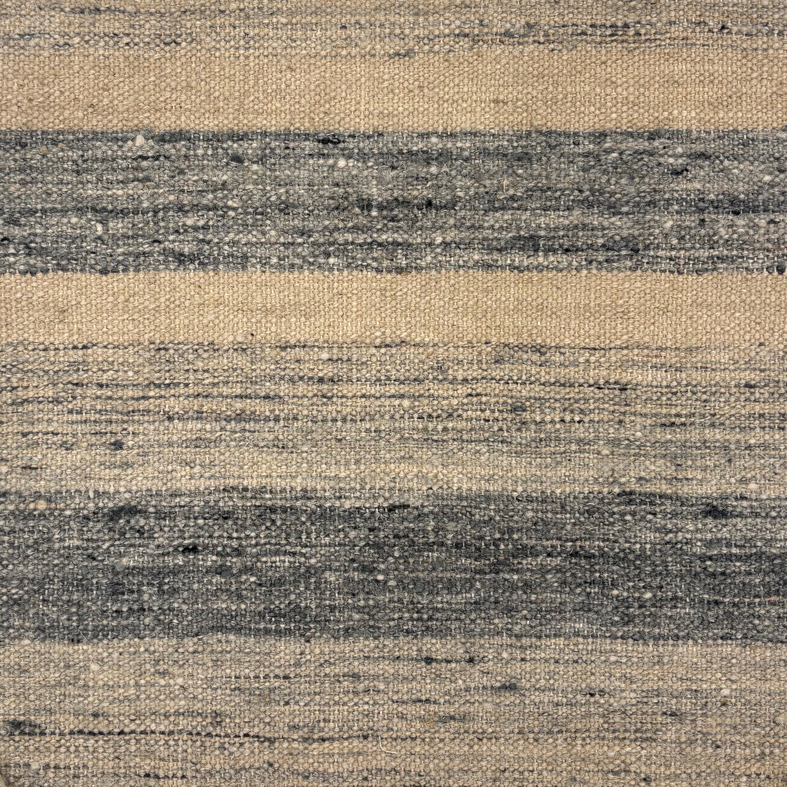 Flatwoven rug in a wide stripe in muted blue with strié cream and navy stripes.