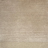 Handkotted rug in cream with a ribbed stripe design. 