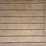 Handknotted rug in a cut pile & loop stripe in taupe.