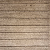 Handknotted rug in a cut pile & loop stripe in taupe.