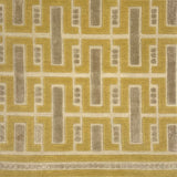 Close-up of a handknotted geometric rug with yellow and ecru colors. 