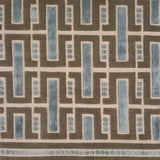 Close-up of a handknotted geometric rug with blue and brown colors