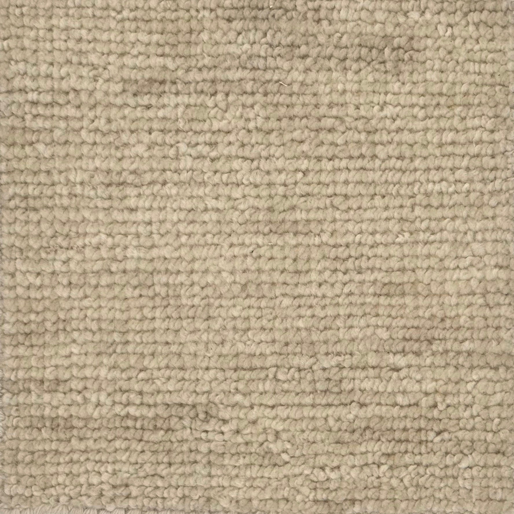 Handknotted rug with subtle texture in cream wool
