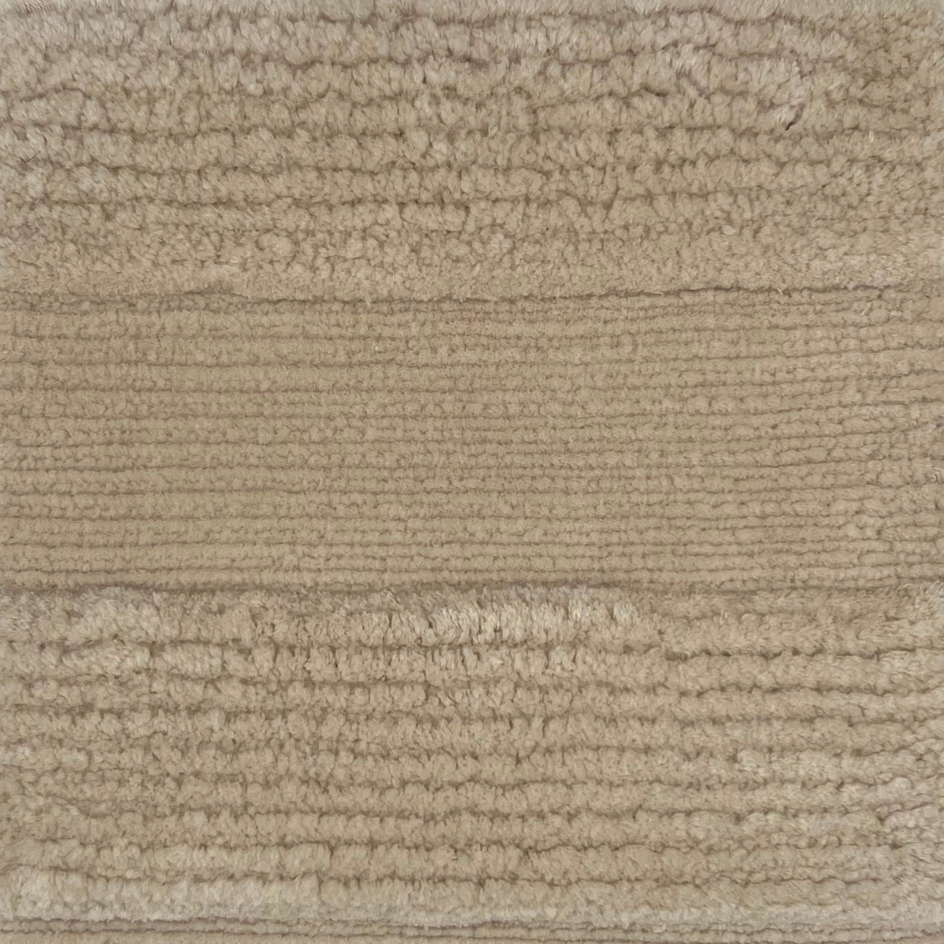 Handknotted rug with a wide raised cut pile stripe in ivory. 
