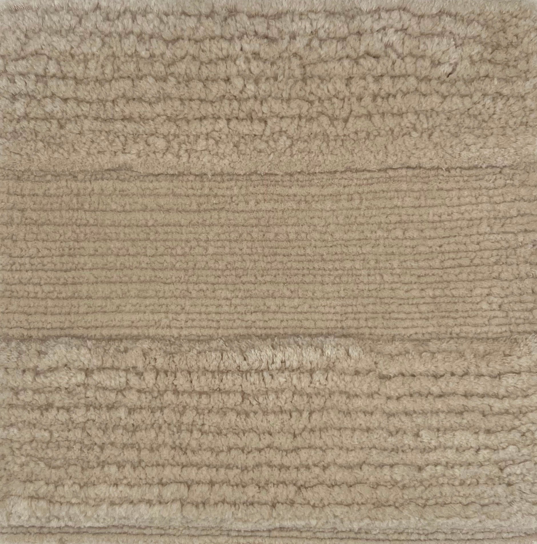 Handknotted rug with a wide raised cut pile stripe in ivory. 