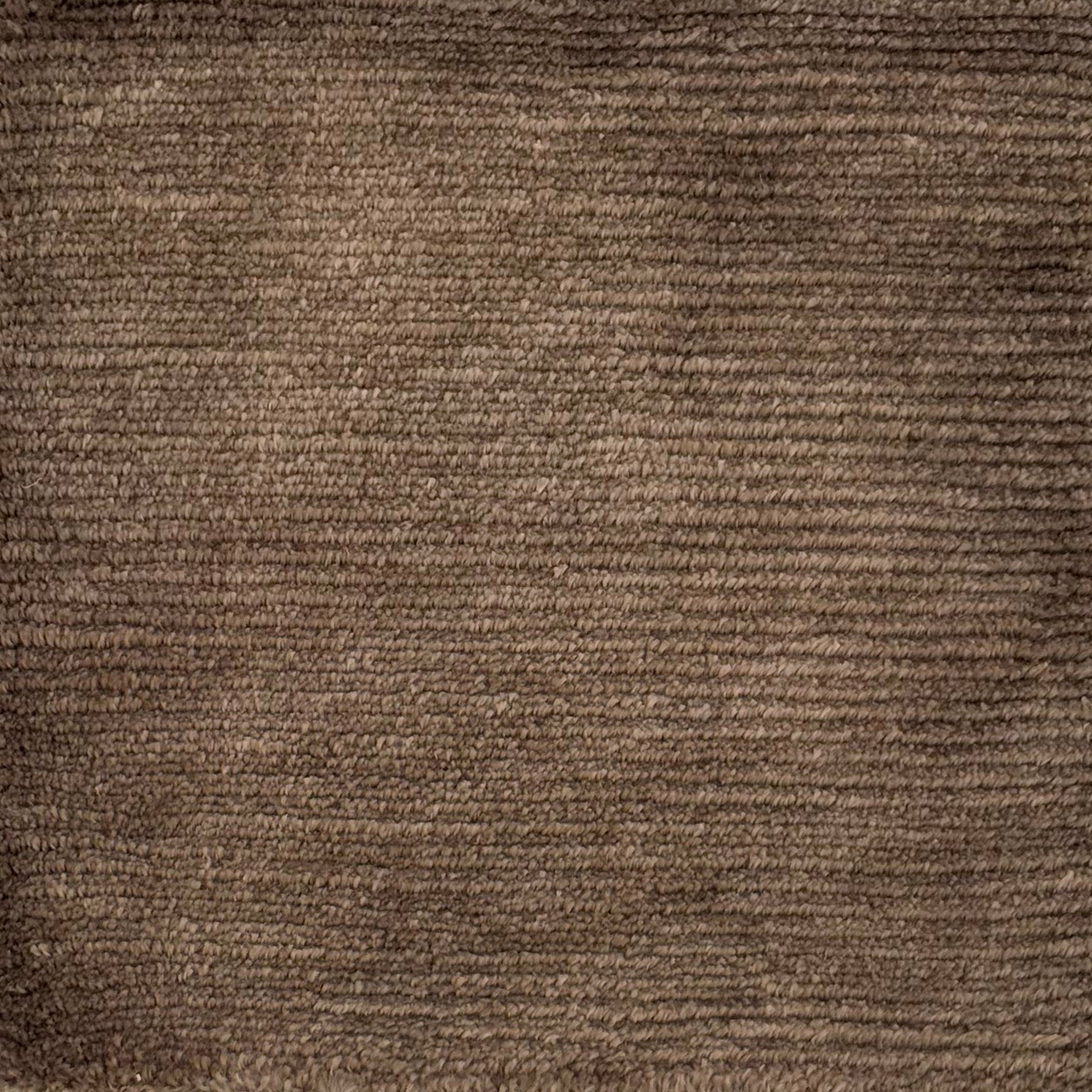 Handknotted rug with solid cut pile in warm brown wool. 