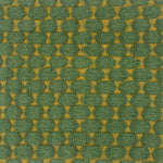 Handwoven rug with green and gold geometric pattern