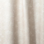 Draped fabric a painterly cloud pattern in white on a beige watercolor field.