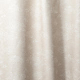 Draped fabric a painterly cloud pattern in white on a beige watercolor field.