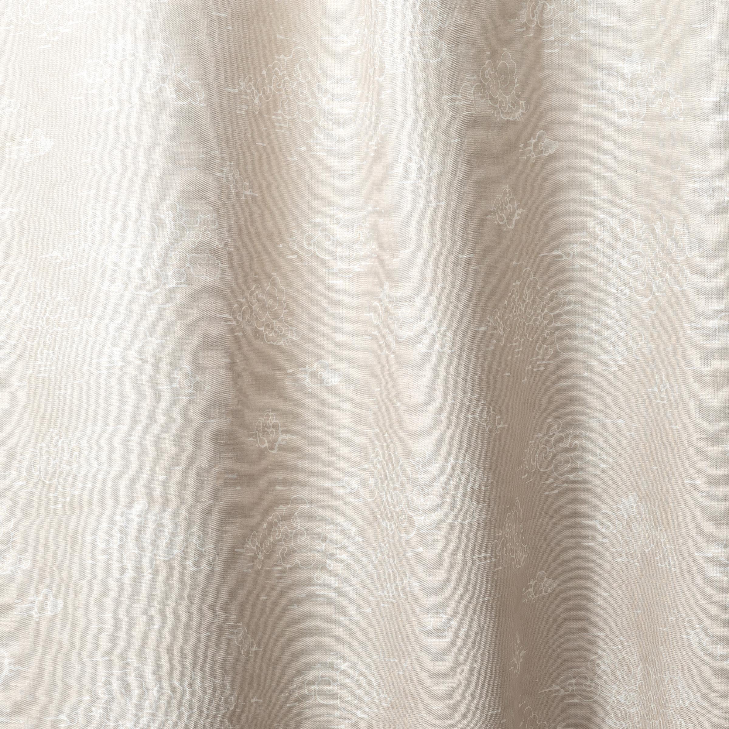Draped fabric a painterly cloud pattern in white on a beige watercolor field.