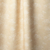 Draped fabric a painterly cloud pattern in white on a pastel yellow watercolor field.