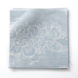 Fabric swatches in a painterly cloud pattern in white on a pastel blue watercolor field.