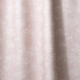 Draped fabric a painterly cloud pattern in white on a pastel pink watercolor field.