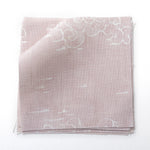 Fabric swatches in a painterly cloud pattern in white on a pastel pink watercolor field.