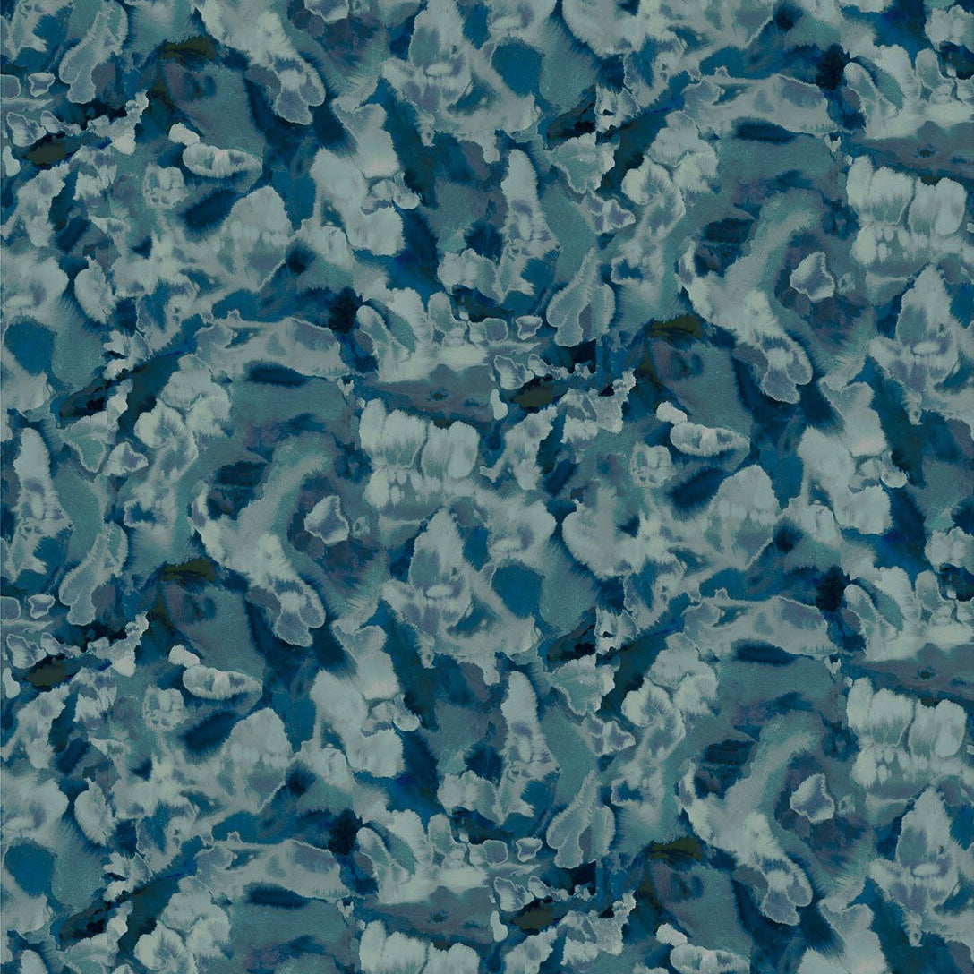 Detail of fabric in an abstract paint print in shades of blue, navy and turquoise.