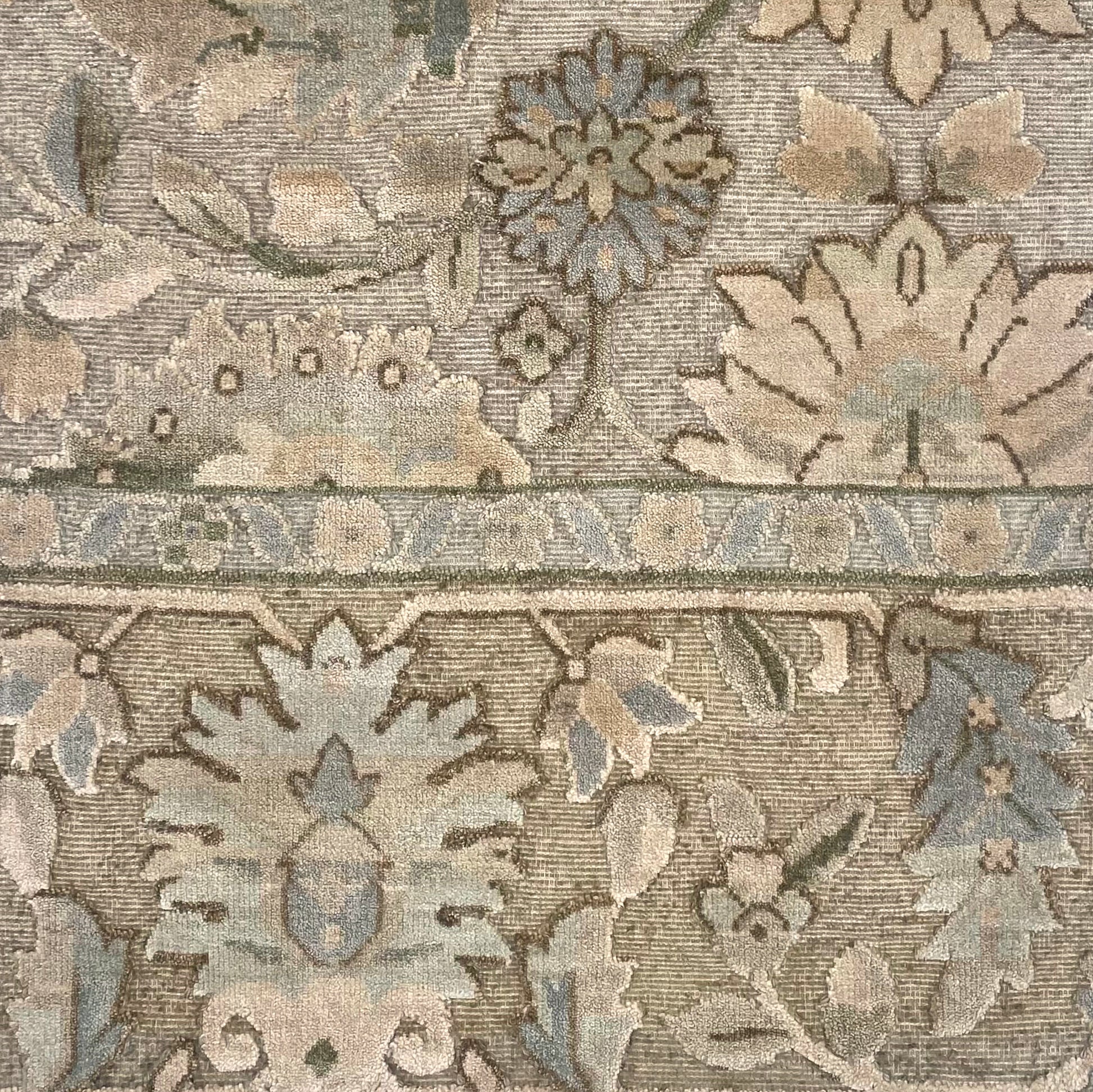 Close-up of a patterned rug with floral and geometric designs.